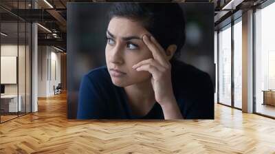 Pensive unhappy young Indian woman look in distance thinking pondering of life problems. Thoughtful millennial mixed race female feel worried anxious about relations. Dilemma, solution concept. Wall mural