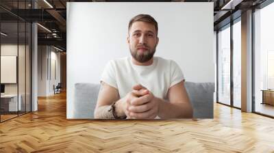 Portrait of happy millennial man making video call on laptop sitting on couch at home, young mentor or trainer record online webinar or training, male communicate or broadcast live on computer Wall mural