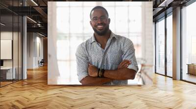 Portrait of smiling african American businessman posing in office Wall mural