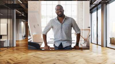 Portrait of smiling african American employee posing in office Wall mural