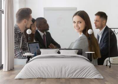 Portrait of smiling businesswoman professional looking at camera at group meeting, ambitious business intern or young project marketing sales manager posing with laptop in office starting career Wall mural