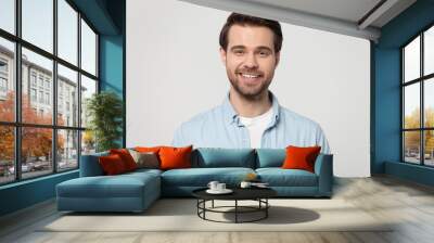 Portrait of smiling Caucasian man posing on grey background Wall mural