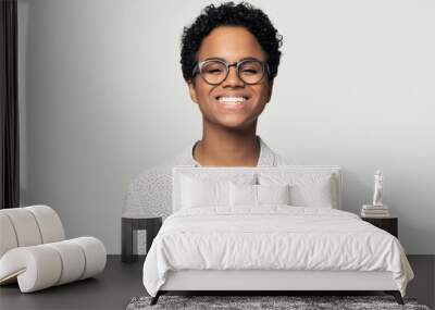 Portrait of smiling ethnic woman posing on studio background Wall mural