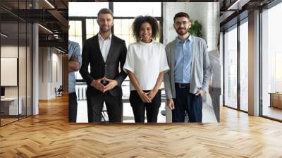 Portrait of standing in row smiling diverse team posing differently looking at camera. Happy young multiethnic corporate staff, bank workers photo shoot, HR agency recruitments. Wall mural