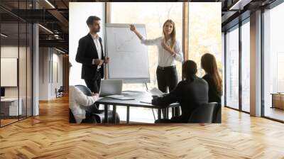 Professional business speakers team give flip chart presentation at meeting Wall mural