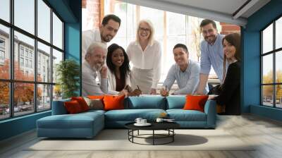 Professional business team young and old people posing at table Wall mural