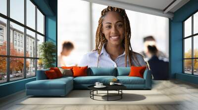 Profile picture portrait of attractive young black lady hipster office team leader member looking at camera with confidence. Pleasant millennial woman skilled business trainer coach pose at workplace Wall mural