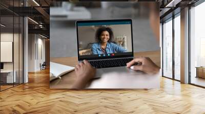 Rear close up view of biracial women talk speak on video call on computer laughing joking. Smiling African American female have webcam online digital conference on laptop. Zoo, virtual event concept. Wall mural