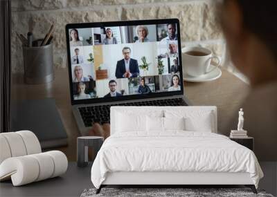 Rear close up view of diverse businesspeople talk on webcam conference conversation brainstorming online, employees colleagues speak on video call on laptop, engaged in internet meeting or briefing Wall mural