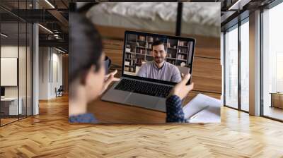 Rear view Indian woman making video call to colleague, using laptop and webcam, involved in online conference, negotiations, internet meeting, distant job interview, student learning language Wall mural