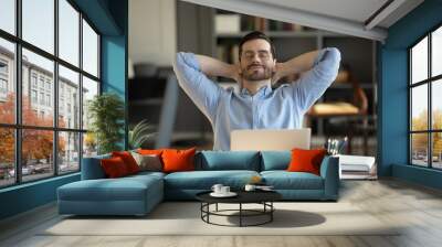 Relaxed man take break from work put hands behind head lean on comfy chair closing eyes feels serenity, enjoy fresh conditioned air in modern office, no stress, fatigue relieve at workplace concept Wall mural