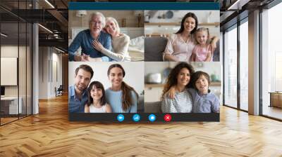 Screen application view of diverse happy relatives sit rest at home on quarantine talk chat on video call, smiling family members have fun engaged in webcam online conversation on computer together Wall mural