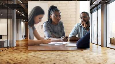 Serious anxious colleagues gathered together in boardroom solve work problems Wall mural