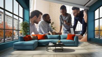 Serious multiracial corporate business team discuss paperwork at group briefing Wall mural