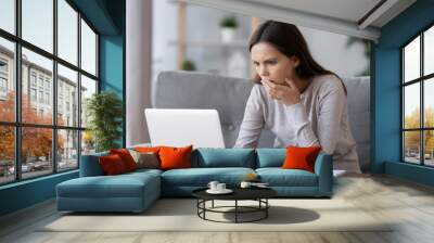 shocked stressed young woman reading bad online news looking at broken laptop screen, confused teen  Wall mural