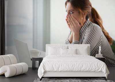 Shocked woman worker looking at laptop screen surprised with bad or unexpected online news, amazed businesswoman feel despair rounding eyes witnessing company bankruptcy or market failure Wall mural