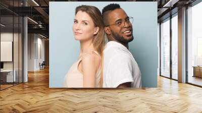 Smiling African American man and woman standing back to back Wall mural