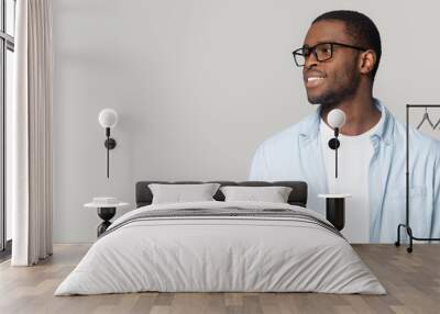 Smiling African American man in glasses looking at copy space Wall mural