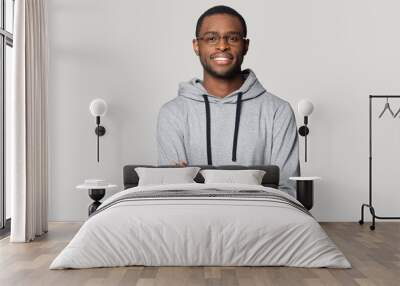 Smiling black male in glasses stand with arms crossed Wall mural