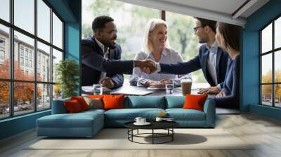 smiling diverse businesspeople shake hands get acquainted greeting at team meeting in office. happy  Wall mural