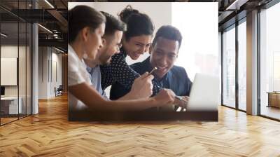 Smiling diverse colleagues laugh brainstorming using laptop Wall mural