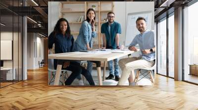 Smiling diverse employees colleagues group portrait in modern boardroom, business people working on financial project statistics together, posing for photo in office, looking at camera Wall mural