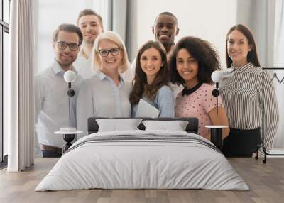 Smiling multiethnic employees posing together for group picture Wall mural