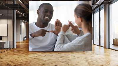 Smiling multiracial friends talk using sign language Wall mural