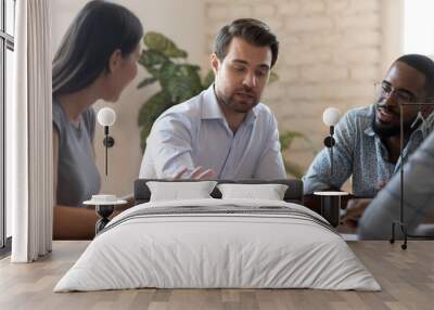 Successful male corporate leader explain paperwork at group office briefing Wall mural