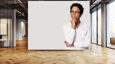 Thoughtful puzzled African American woman looking aside at copy space Wall mural