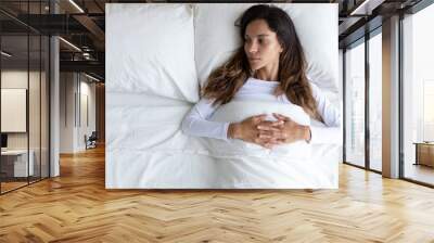 Top view of pensive young woman lying alone in cozy white bed thinking or pondering over relationships problem, depressed millennial girl relax in bedroom lost in thoughts after break up or divorce Wall mural