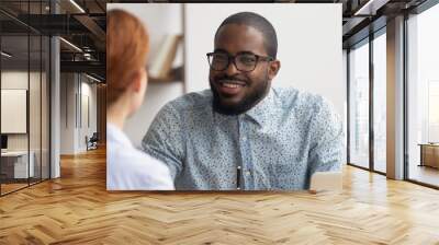 Two multiracial business partners speaking, discussing, sharing ideas Wall mural