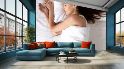 Vertical, beautiful young woman sleeping in comfortable bed Wall mural