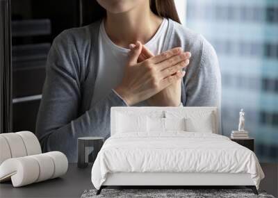 With all my heart. Close up of young lady hands folded close to heart in peaceful candid sincere sign gesture appreciating destiny god for help, expressing heartfelt thank you to friend mate colleague Wall mural