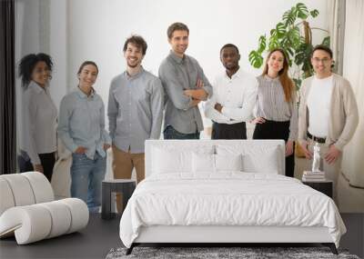 Young happy multiracial professionals or company staff looking at camera smiling, multi-ethnic group of diverse business people standing together, employees posing in office, successful team portrait Wall mural