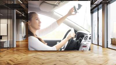 Young woman, a drowsy drive, yawning sitting at the drivers seat in the car, causing a danger of driving because of a serious lack of sleep Wall mural