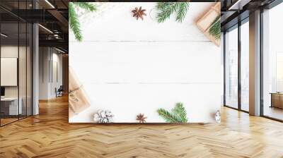 Christmas composition. Christmas gifts, fir tree branches, knitted blanket on white wooden background. Flat lay, top view, copy space Wall mural