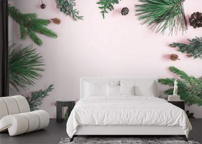 Christmas composition. Coniferous tree branches on pastel pink background. Christmas, winter, new year concept. Flat lay, top view, copy space Wall mural