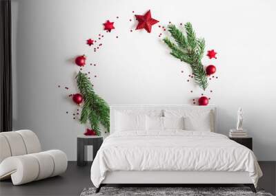 Christmas composition. Fir tree branches, red and green decorations on white background. Christmas, winter, new year concept. Flat lay, top view, copy space Wall mural