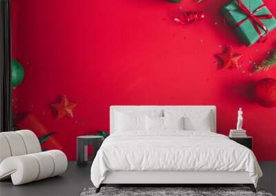 Christmas composition. Gift box, christmas decorations on red background. Flat lay, top view, copy space Wall mural