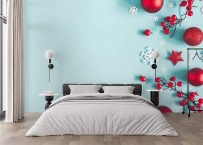 Christmas or winter composition. Frame made of snowflakes, balls and red berries on pastel blue background. Christmas, winter, new year concept. Flat lay, top view, copy space Wall mural