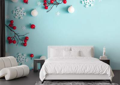 Christmas or winter composition. Snowflakes and red berries on blue background. Christmas, winter, new year concept. Flat lay, top view, copy space Wall mural