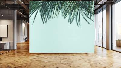 Summer composition. Tropical palm leaves on pastel blue background. Summer concept. Flat lay, top view, copy space Wall mural