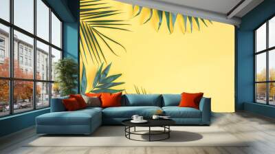 Tropical palm leaves on yellow background. Summer concept. Flat lay, top view, copy space Wall mural