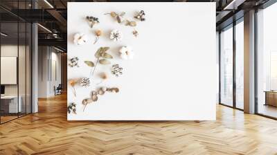 Winter composition. Dried leaves, cotton flowers, berries, pine cones on gray background. Autumn, fall, winter concept. Flat lay, top view, copy space Wall mural