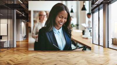 African American businesswoman smiling while walking in an offic Wall mural