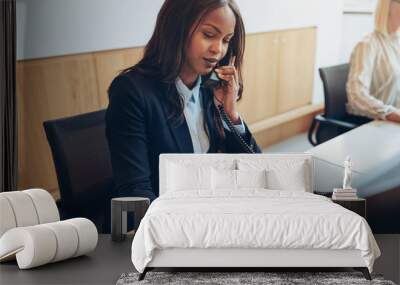 African American businesswoman taking phone messages in an offic Wall mural