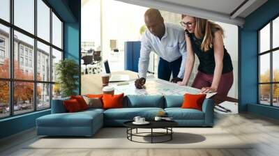 Architects working on a building plan together in an office Wall mural