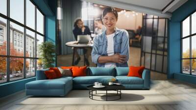 Asian businesswoman smiling with colleagues sitting in the backg Wall mural