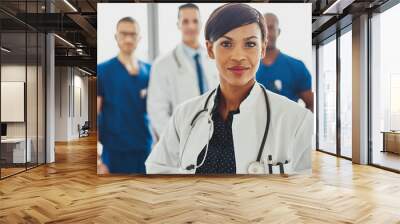 Black female doctor leading medical team Wall mural